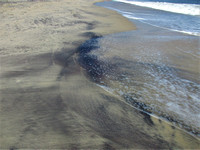 Black sand and the sea